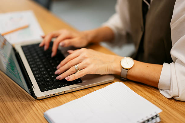 istock Woman typing on laptop working in modern office 2245004626