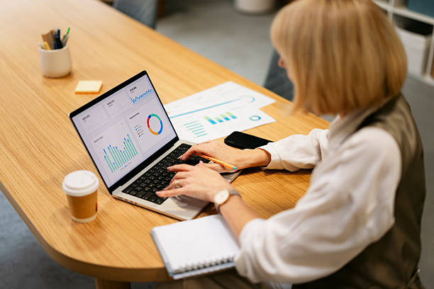 istock Businesswoman analyzing financial data on laptop in office 2245004661