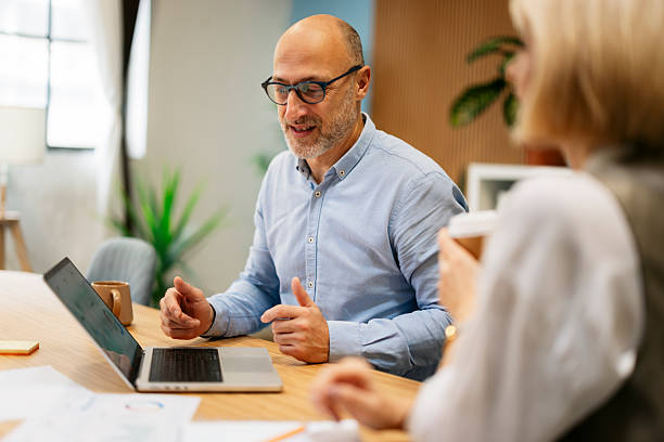 istock Business colleagues collaborating on laptop during office meeting 2245004683