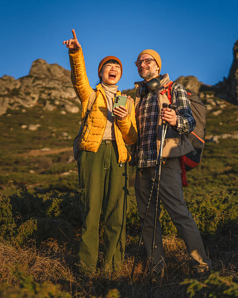 istock Happy diverse couple hiking in mountains exploring nature 2245005867