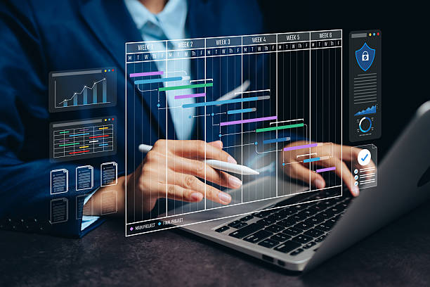 istock Project management schedule concept. Businessman using laptop and stylus with virtual Gantt chart for planning, workflow tracking, and digital project performance analysis 2245010013