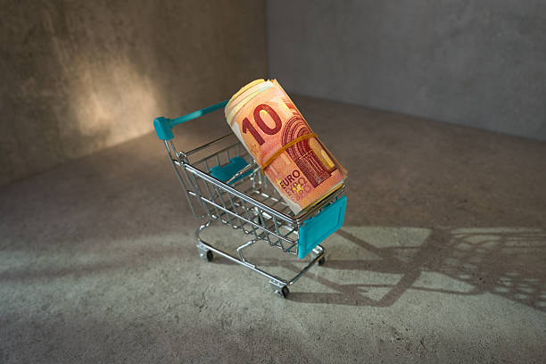 Shopping cart with rolled Euro Banknotes