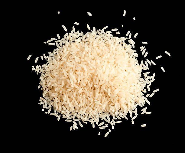 istock A pile of uncooked rice grains isolated on black background 2245011511
