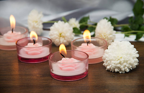 istock Candles and flowers on wooden table 2245012830