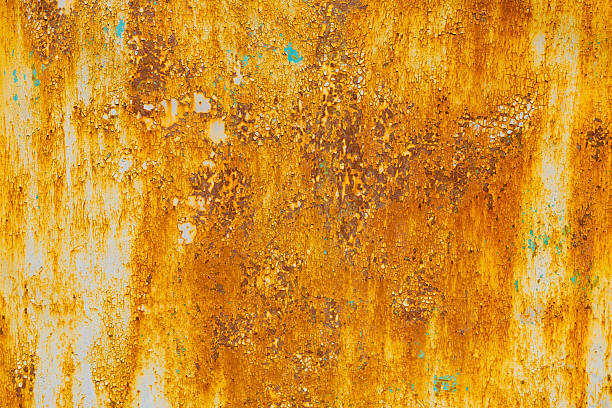 istock Extensively rusted metal with peeling white paint 2245015396