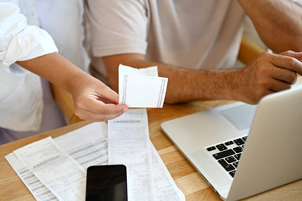 istock man and a woman are calculating a budget 2245015947
