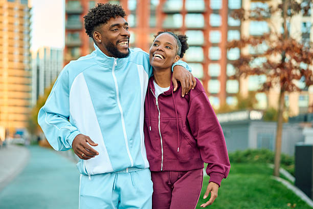 istock Young black couple training outdoors together with tracksuits 2245019894