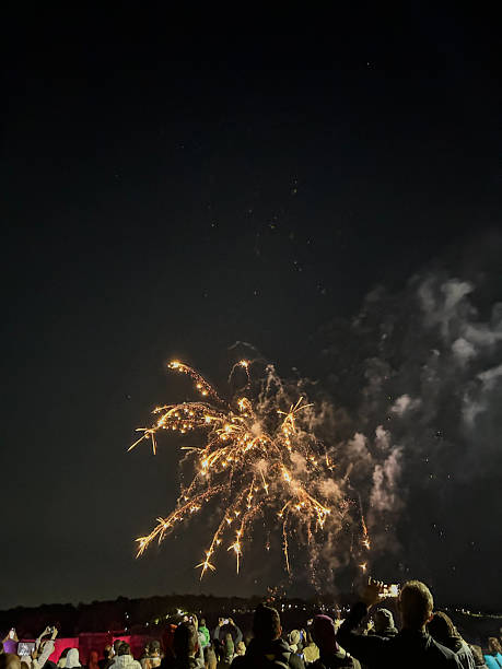 istock City Crowd Enjoying Fireworks Celebration Under Urban Skyline at Night 2245021664