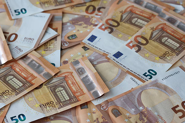 istock Fifty euro banknotes scattered on table 2245021850