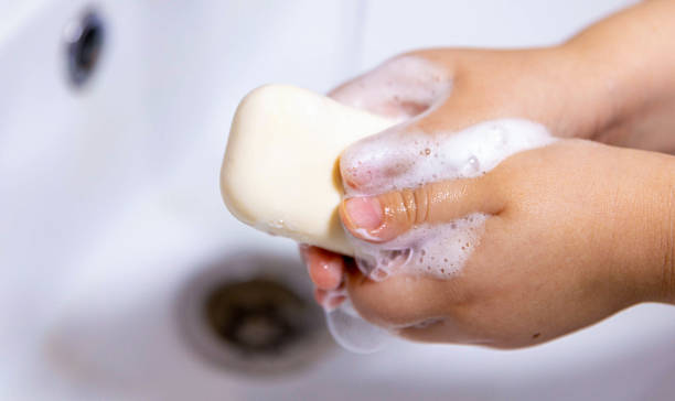 istock Child washing hands with soap foam and water. 2245021865
