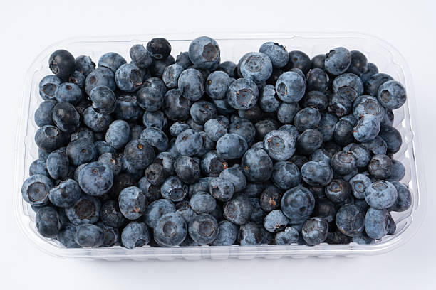 istock Blueberries in a plastic container isolated on a white background. 2245026945