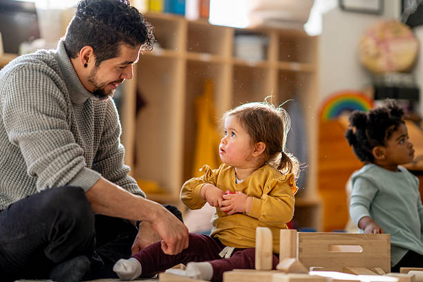 istock Father Interacting With Diverse Children During Playtime At Daycare Center 2245028385