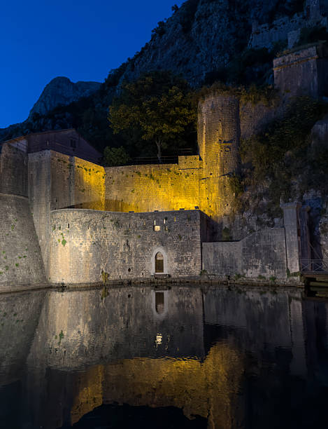 istock Illuminated Kotor Walls Reflected in Water at Night 2245032100