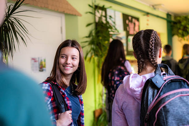 istock Teenager students smiling in school hallway 2245032113
