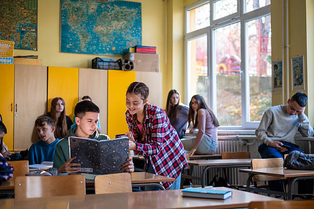 istock Teenagers collaborating on school project in classroom 2245032181