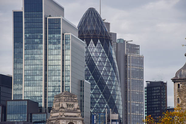 London, UK - November 4 2025:  exterior view of 30 St Mary Axe, known as the Gherkin building, and other skyscrapers in the City of London, the capital's financial district.