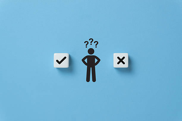 istock Decision making and choosing between the right and wrong. Confusion about to accept or to reject. Stickman with question mark standing in between the dice with check mark and x symbols 2245038696