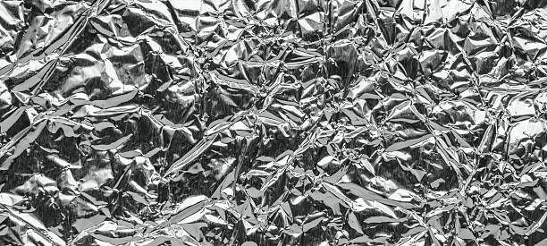 istock Shiny metal silver gray foil leaf crumpled texture background 2245045636