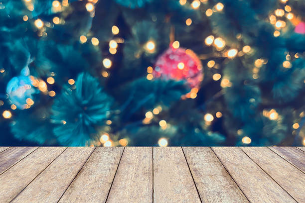 istock Empty wood table top with blur Christmas tree with bokeh light background 2245046240