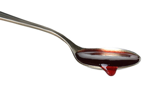 istock Spoon with tasty sweet jam isolated on white 2245053370