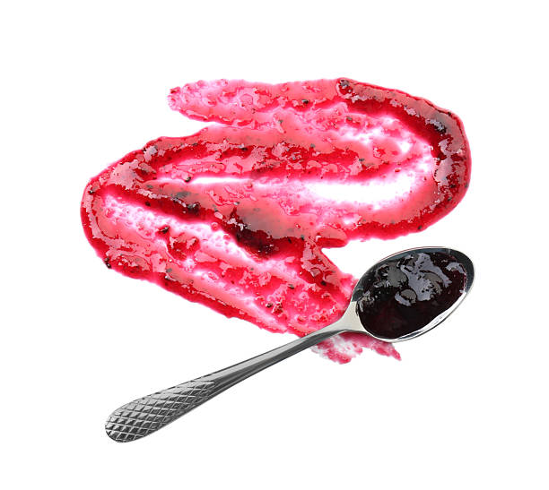 istock Tasty sweet jam and spoon isolated on white, top view 2245053409