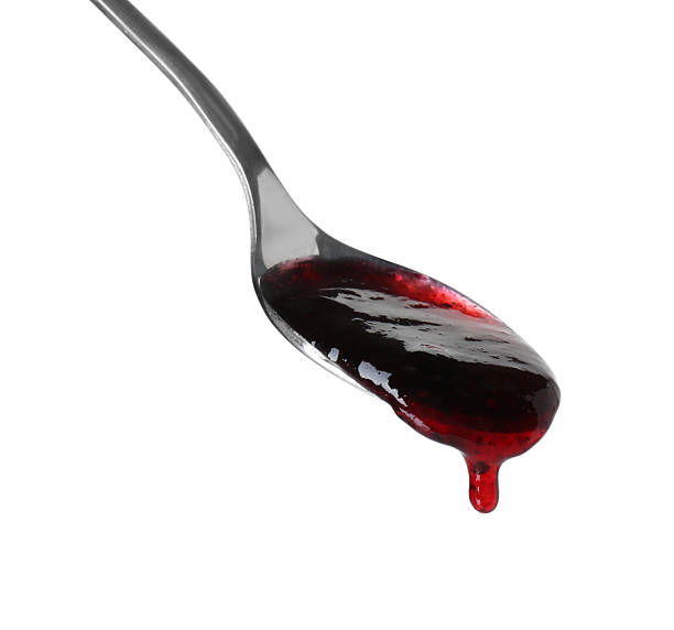 istock Spoon with tasty sweet jam isolated on white 2245053424