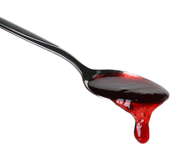 istock Spoon with tasty sweet jam isolated on white 2245053475