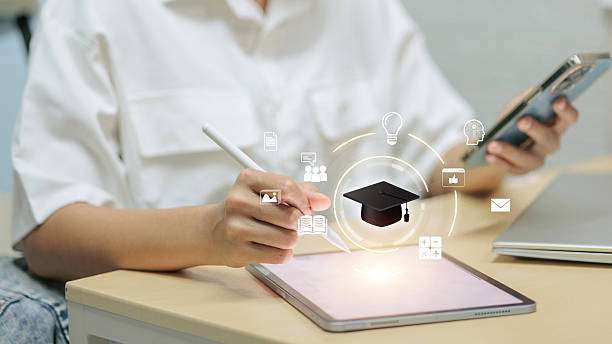 istock Student using tablet and stylus with smartphone, graduation cap icons, online learning concept 2245055404
