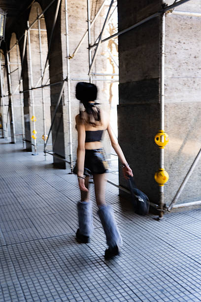 istock Woman walking fast with motion blur in urban setting 2245056399