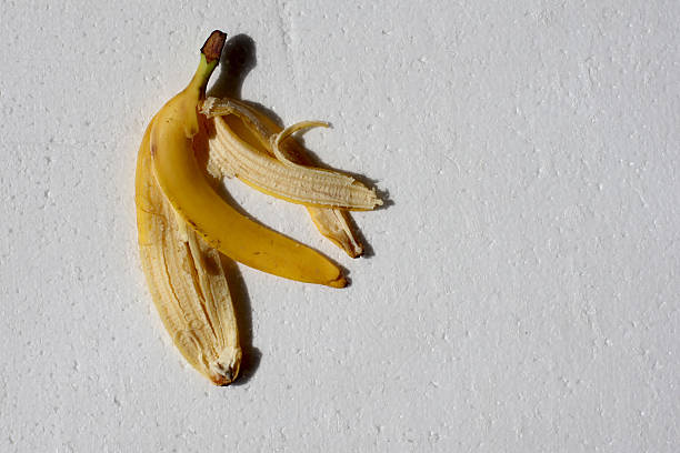 Banana peel lays on a white field.