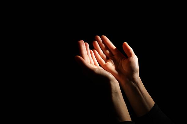 istock Religion. Woman with open palms praying on black background, closeup. Space for text 2245059889