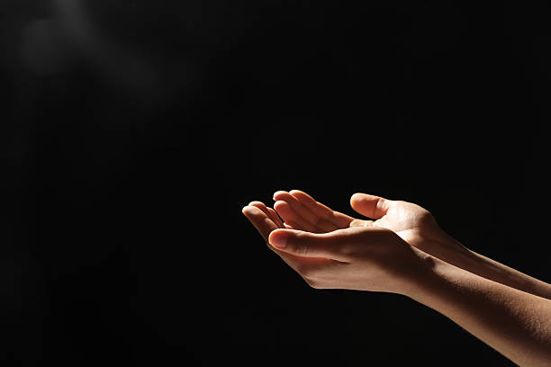 istock Religion. Woman with open palms praying on black background, closeup. Space for text 2245059899