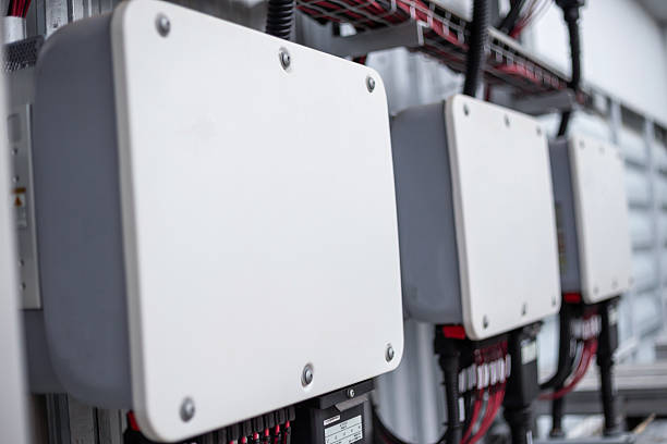 istock Inverter behind the solar panels.DC cable connects electricity from the solar panel to the inverter. 2245061202