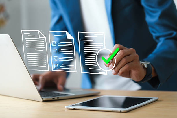 istock Man holding a pen pointing to document and mark correct sign for standard quality control certification assurance concept. 2245061235