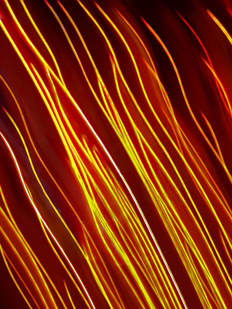 istock Colorful glow sparks streams of light texture. Orange red rays on dark background .Flare abstract effect. 2245062749