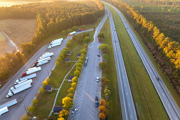 istock Parking rest area for cargo tractor-trailers near American interstate freeway. Resting place during interstate goods hauling in USA 2245063749