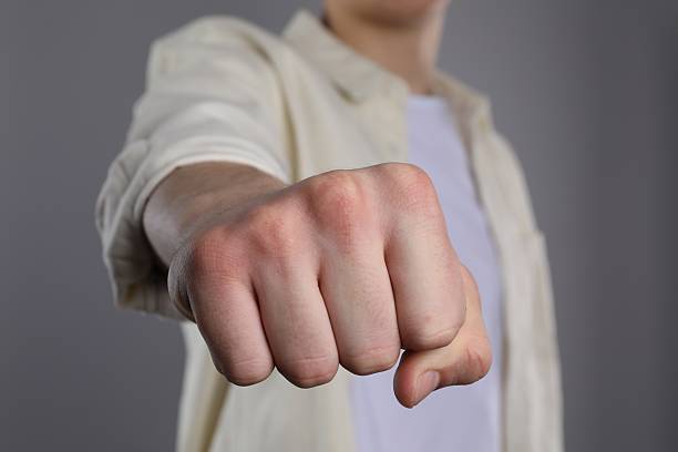 istock Man showing fist with space for tattoo on grey background, selective focus 2245064339