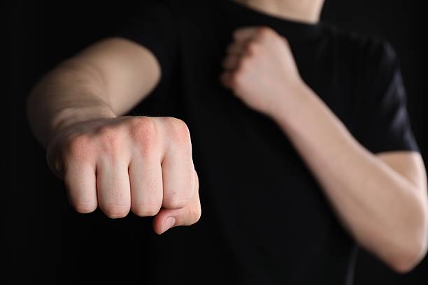 istock Man showing fist with space for tattoo on black background, selective focus 2245064342