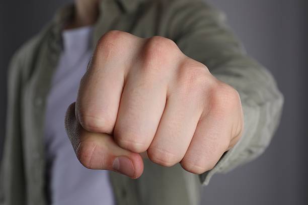 istock Man showing fist with space for tattoo on grey background, selective focus 2245064361