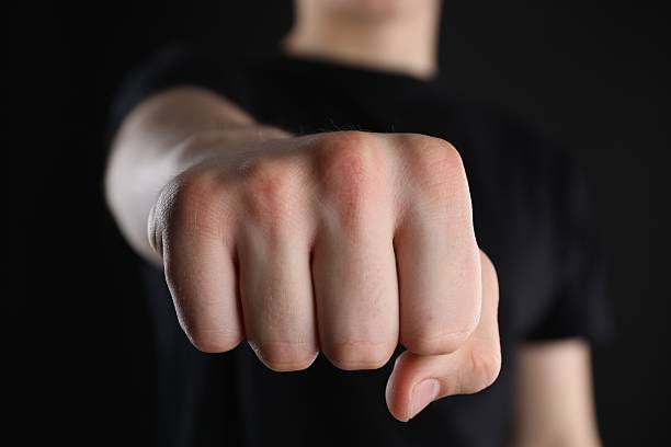 istock Man showing fist with space for tattoo on black background, selective focus 2245064377