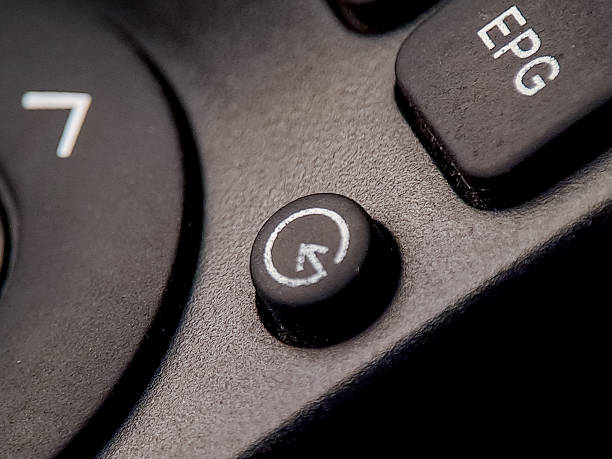 istock Macro of a remote control showcases button details and textured surface in dramatic lighting. 2245067313