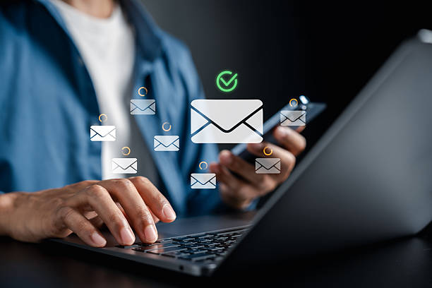 istock Email sending concept with envelope floating above laptop and smartphone interface. digital communication, online messaging, email marketing, and cloud-based mailing system. 2245072127