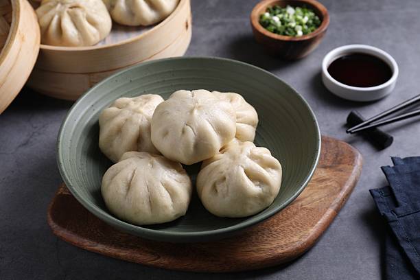 istock Delicious bao buns (baozi) in bowl on grey table, closeup 2245072249