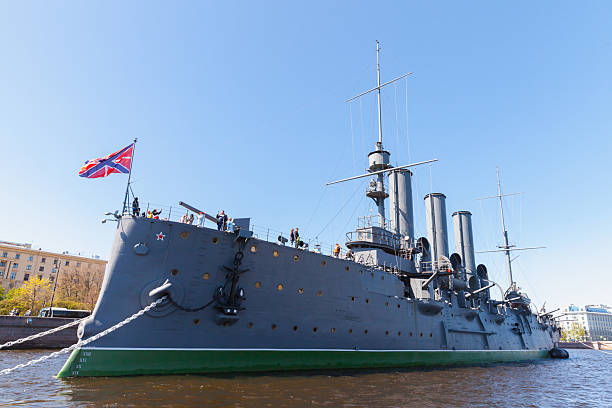 St-Petersburg, Russia - May 21, 2022: A monumental warship sits anchored along the riverfront. Aurora is a Russian protected cruiser currently preserved as a museum ship