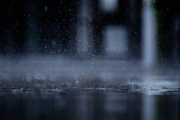 istock heavy raining make many small splash crown from water droplets drop down to the concrete floor in blue tone color scene 2245077748