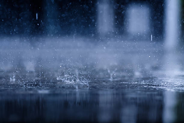 istock heavy raining make many small splash crown from water droplets drop down to the concrete floor in blue tone color scene 2245077890
