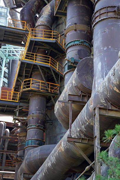 istock Industrial pipes and structures with yellow safety rails 2245079160