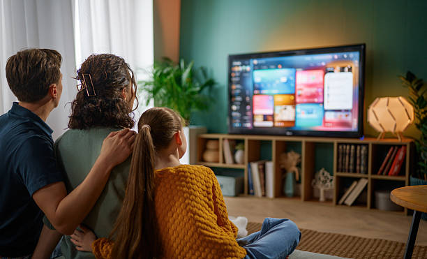 istock family watching  TV at home 2245080483
