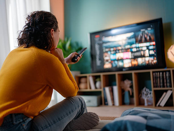 istock woman watching TV 2245080517
