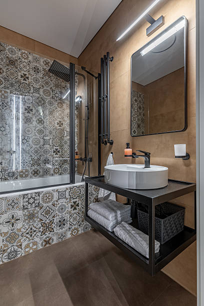 istock Contemporary Bathroom Interior with Patterned Tiles and Elegant Lighting 2245080672